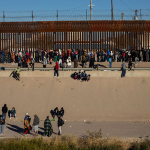 A group of people stands by the border wall, reflecting on the challenges of denied asylum claims - The Law & ADR Offices of Alicia Khoo